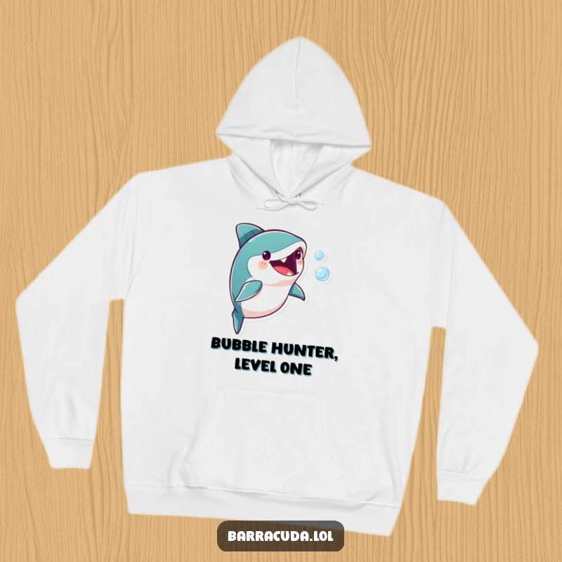 Funny barracuda character enthusiastically pursuing a single, translucent bubble, showcasing a humorous and playful scene on this hoodie.