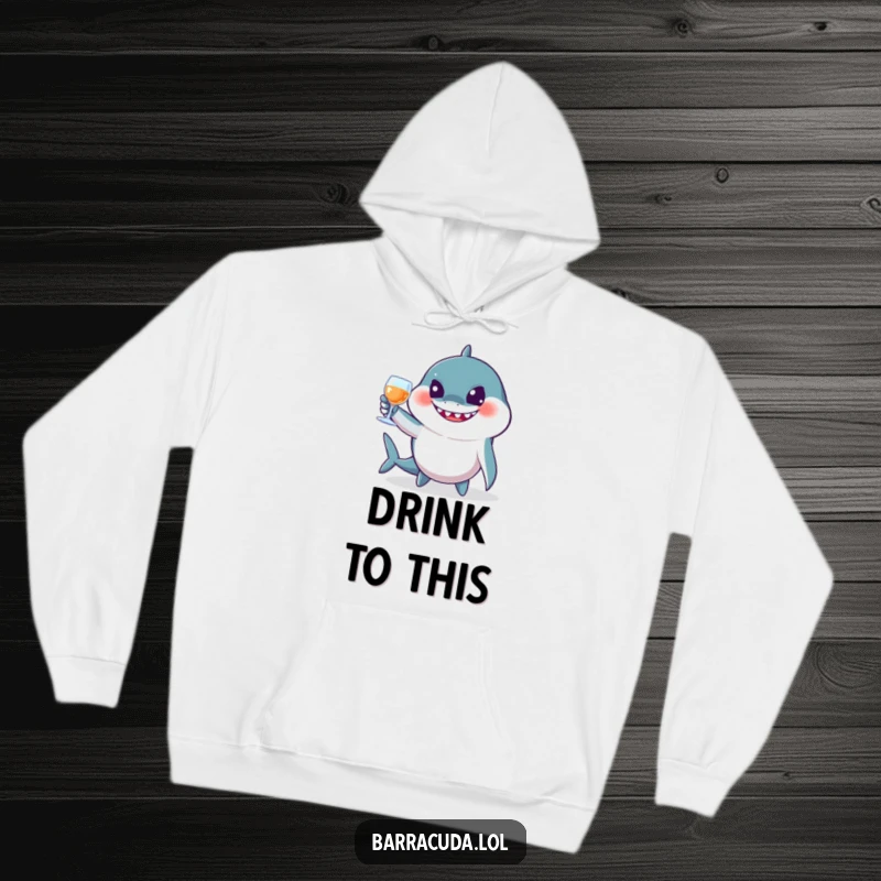 Funny barracuda hoodie depicting a jovial fish toasting with imaginary glasses, offering warmth and a humorous celebration theme.